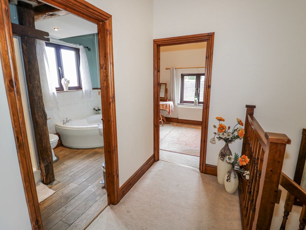 A hallway with a bathroom and a room at The Haybarn in Lichfield