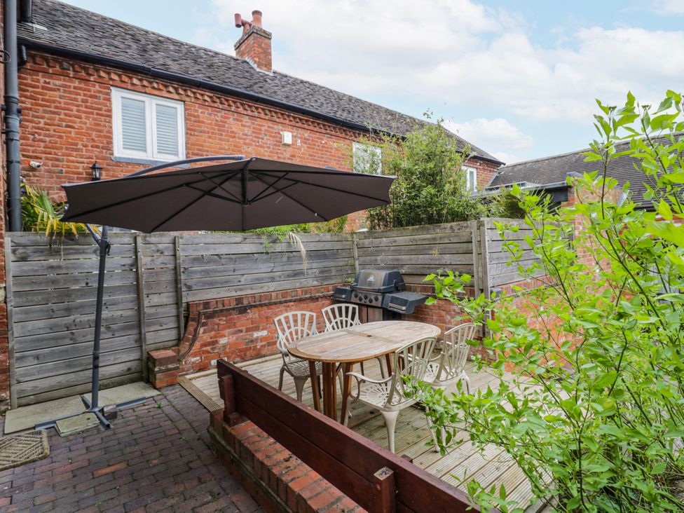 An outdoor area with a table and chairs at The Haybarn in Lichfield