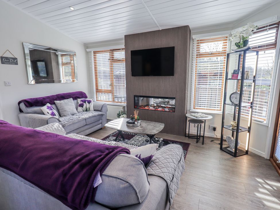 A living room with sofas and a coffee table at JacMar Lodge 14 Applethwaite, Limefitt Park near Windermere