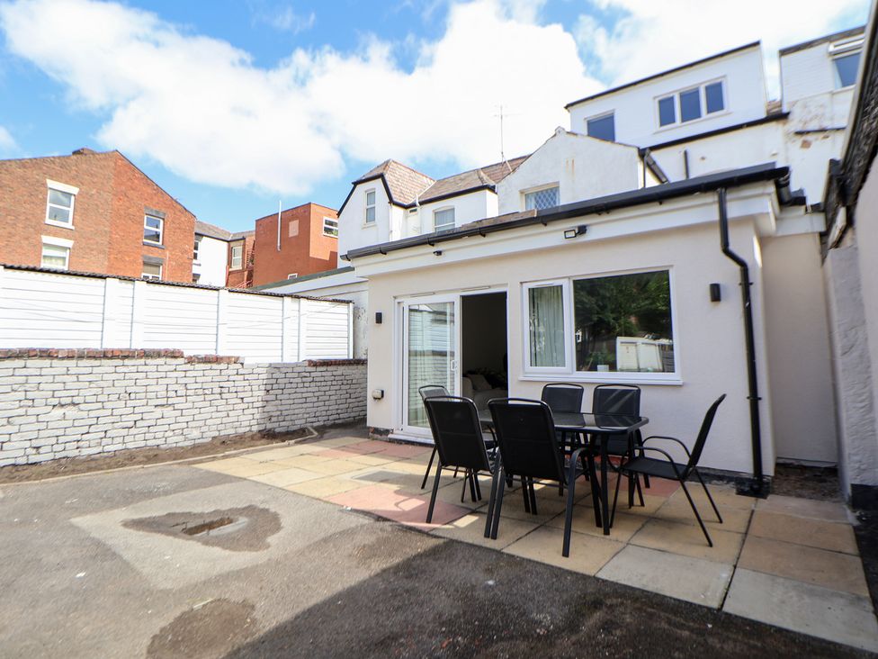 An outdoor area with a dining table and chairs at The Alhambra in Southport