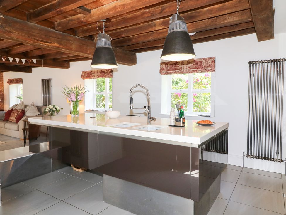 A kitchen with an island and sink at The Old Barn in Caenby near Market Rasen