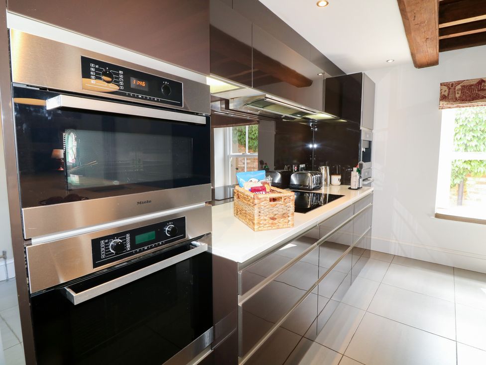A kitchen featuring stainless steel appliances and a storage basket at The Old Barn in Caenby near Market Rasen