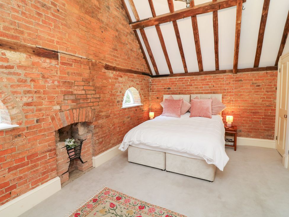 A bedroom with a bed and bedside tables at The Old Barn in Caenby near Market Rasen