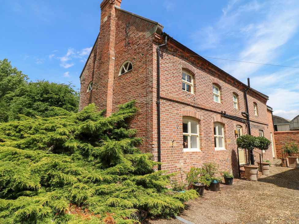 Exterior view of a brick building with plants at The Old Barn in Caenby near Market Rasen