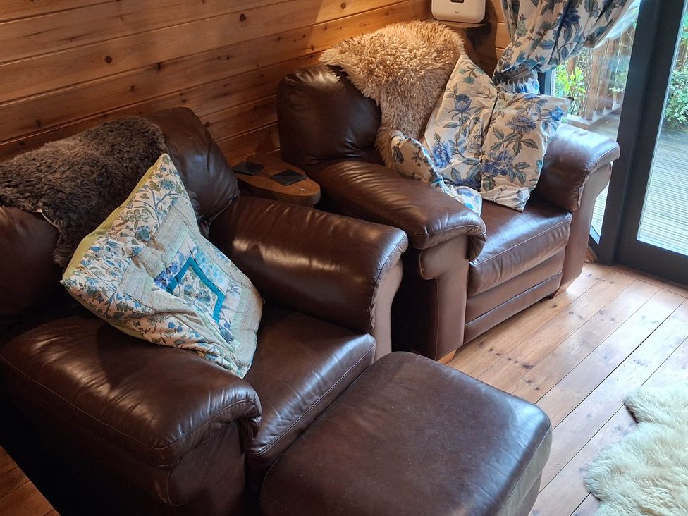 Two brown armchairs with cushions in a living room at The Kites Nest in Pont-rhyd-y-groes near Pontrhydfendigaid, Snowdonia