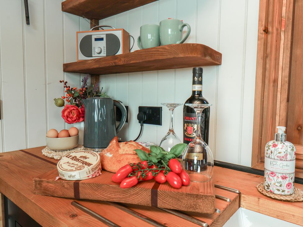 A kitchen countertop with a kettle, radio, glasses, and food items at Lodge Farm in Whitby
