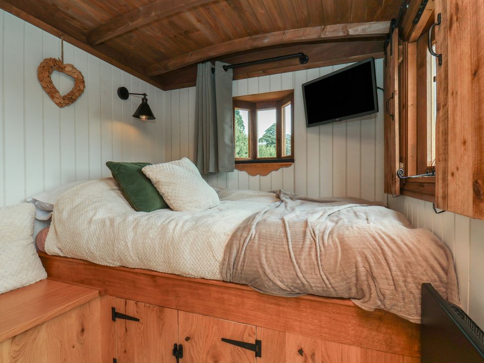 A bedroom with a bed and windows at Lodge Farm in Whitby