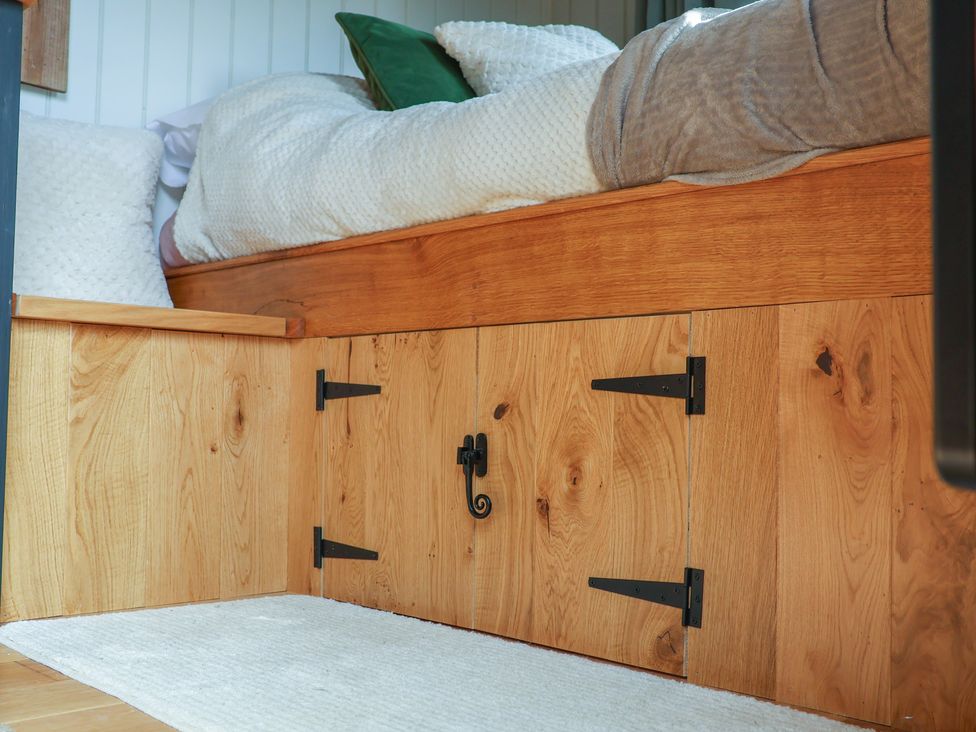 A storage unit with bed on top and pillows at Lodge Farm in Whitby