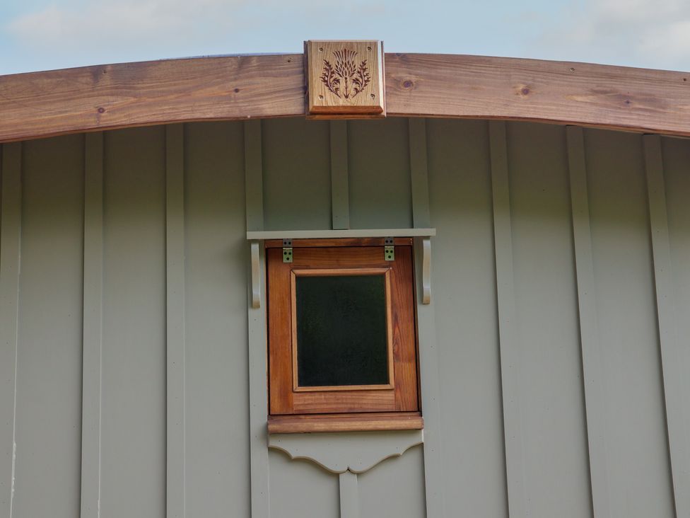 A wooden panel with a small window at Lodge Farm in Whitby