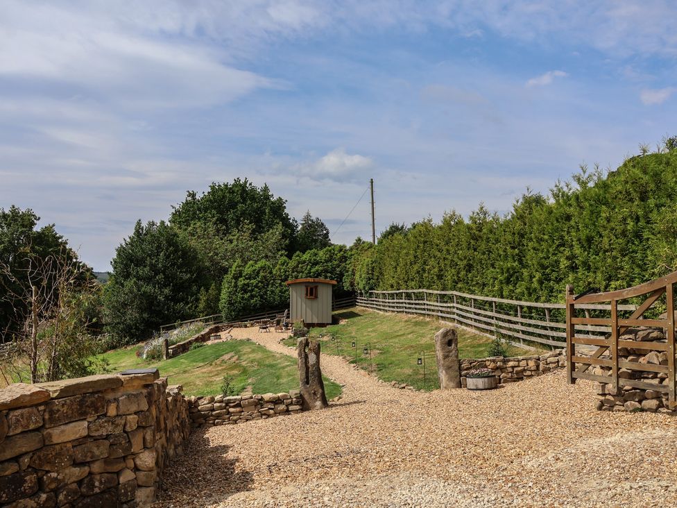 An outdoor space with gravel path and a shed at Lodge Farm in Whitby
