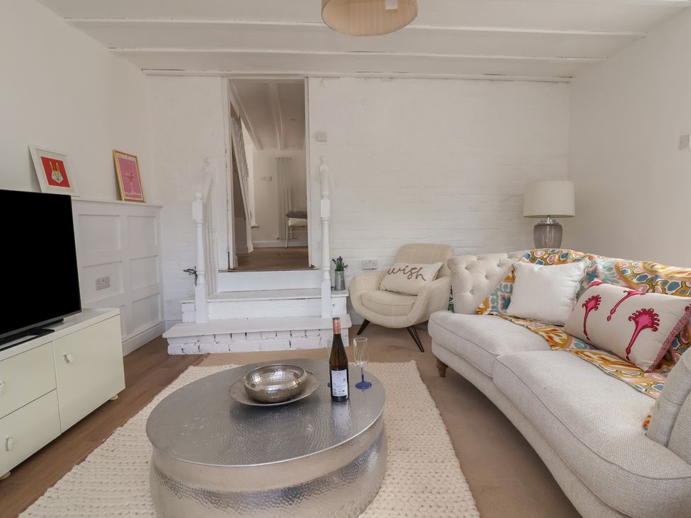 A living room with a coffee table and sofa at The Studio Cottage in Denbigh