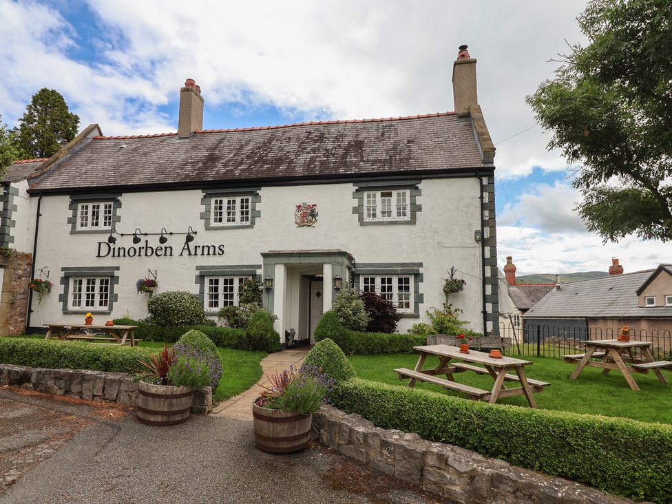 The exterior of Dinorben Arms pub with outdoor seating at The Studio Cottage in Denbigh