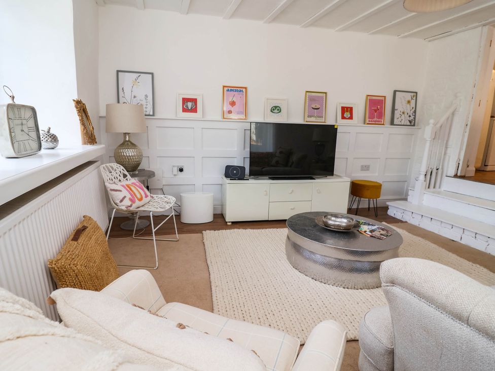 A living room with a television and seating at The Studio Cottage near Denbigh