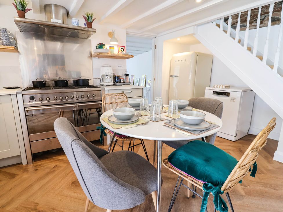 A kitchen with a dining table and chairs at The Studio Cottage near Denbigh