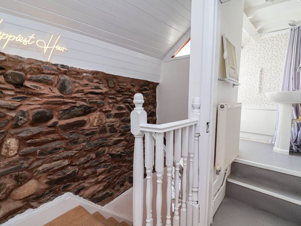 A staircase with stone wall and radiator at The Studio Cottage near Denbigh
