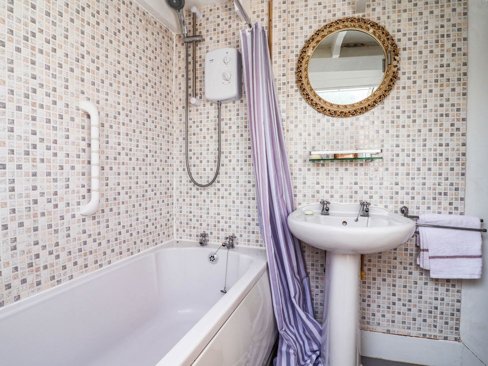 A bathroom with a bathtub and sink at The Studio Cottage near Denbigh