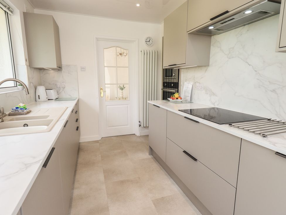 A kitchen with cabinets and a sink at Oaklea in Keswick