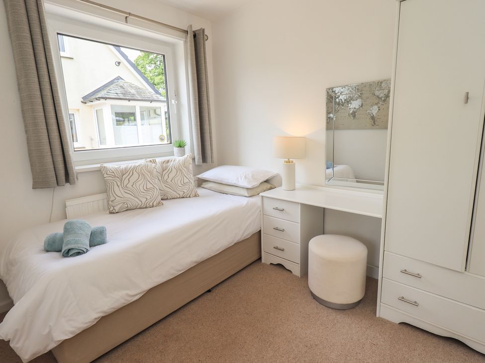 A bedroom with a bed and desk at Oaklea in Keswick