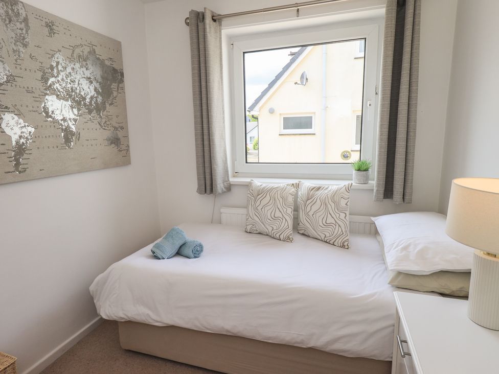 A bedroom with a bed and wall art at Oaklea in Keswick