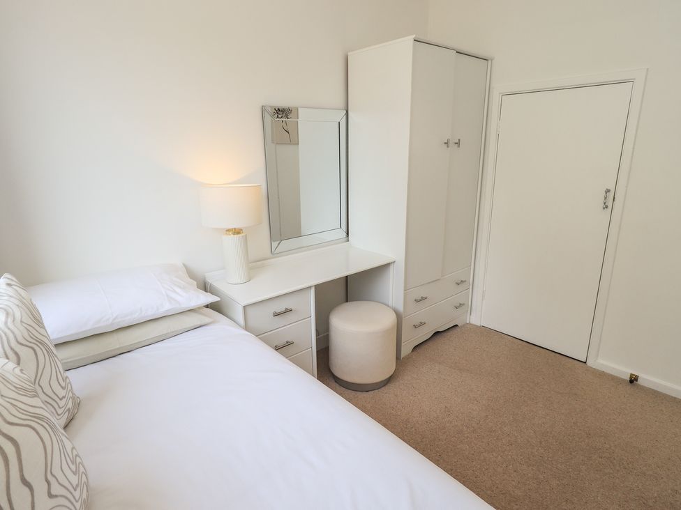 A bedroom with a bed and dresser at Oaklea in Keswick