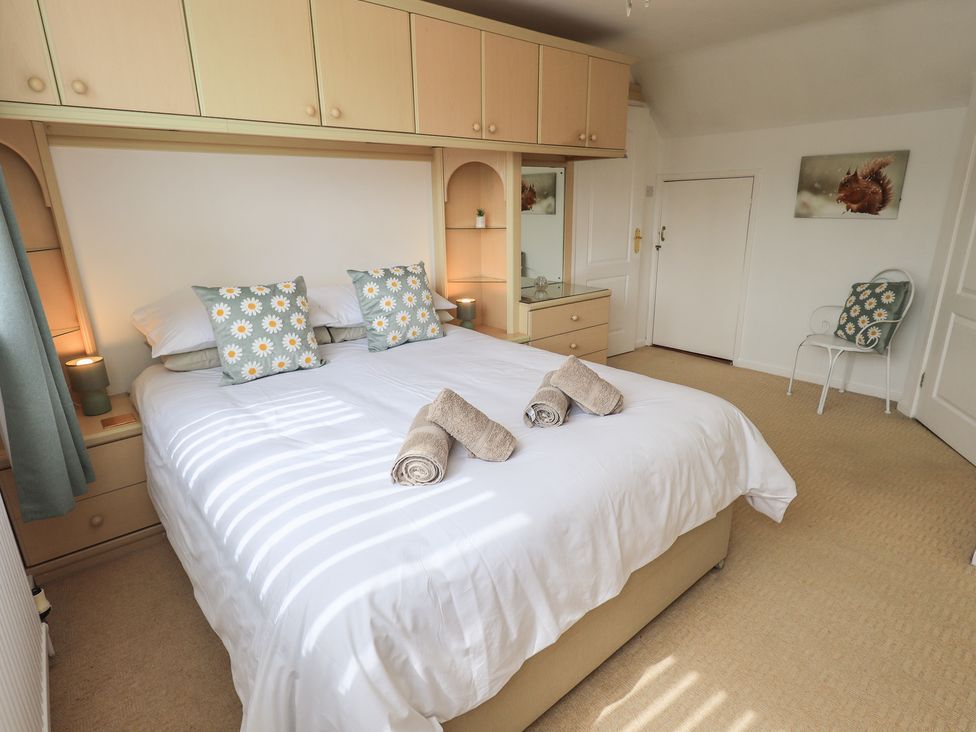 A bedroom with a double bed and bedside furniture at Oaklea in Keswick
