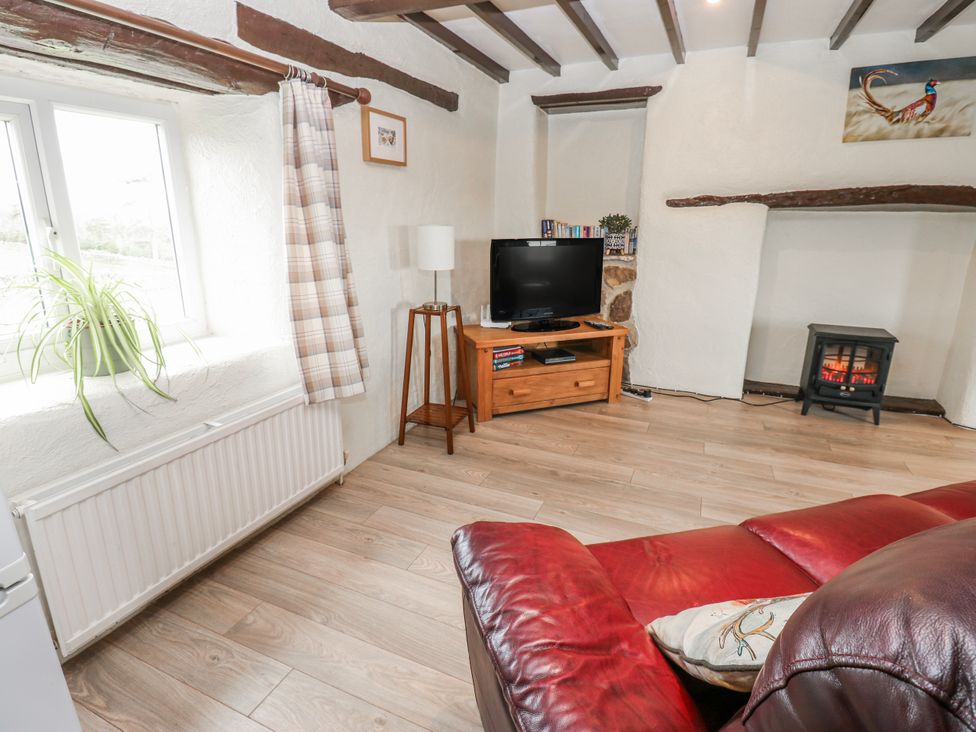A living room with a tv and sofa at The Granary in Ellingstring near Masham