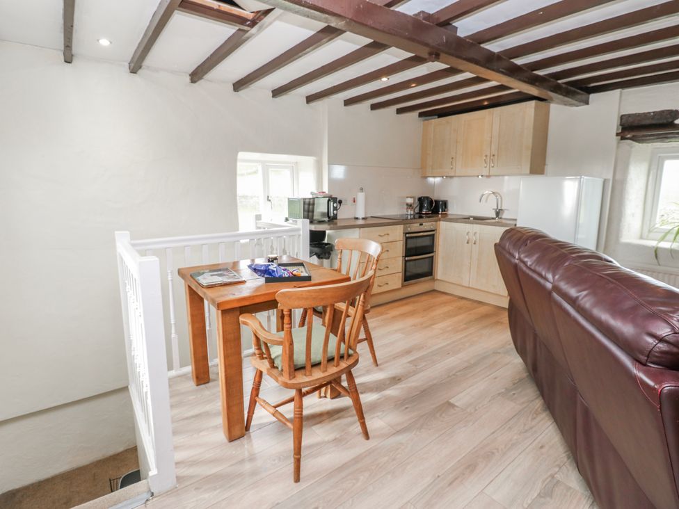 A kitchen with a seating area and appliances at The Granary in Ellingstring near Masham