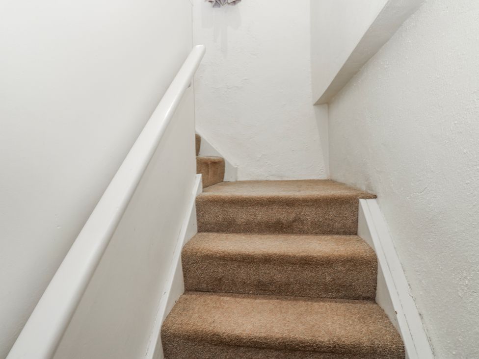 A staircase with carpeted steps and a handrail at The Granary in Ellingstring near Masham
