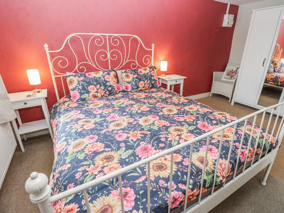 A bedroom with a bed and bedside table at The Granary in Ellingstring near Masham