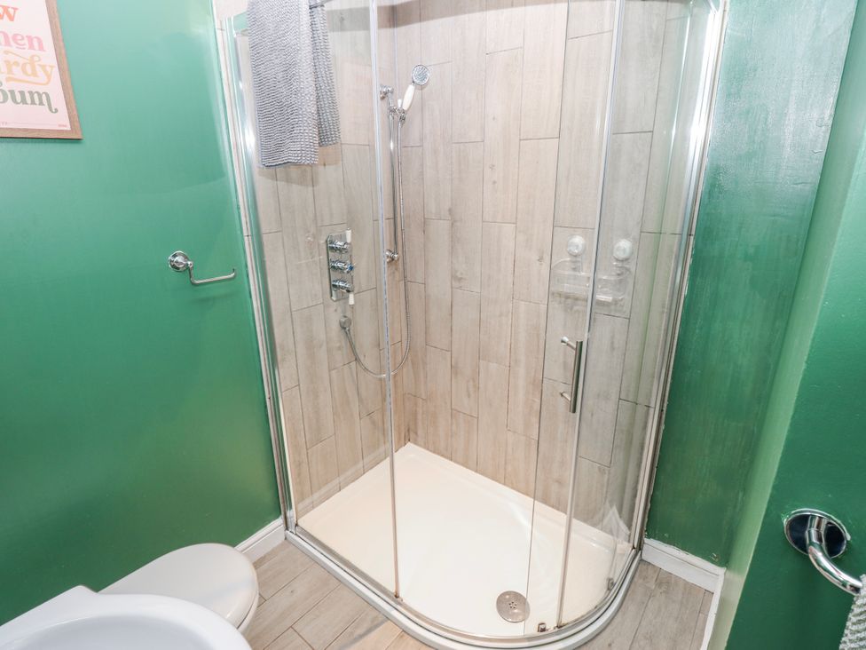 A bathroom with a shower and toilet at The Granary in Ellingstring near Masham