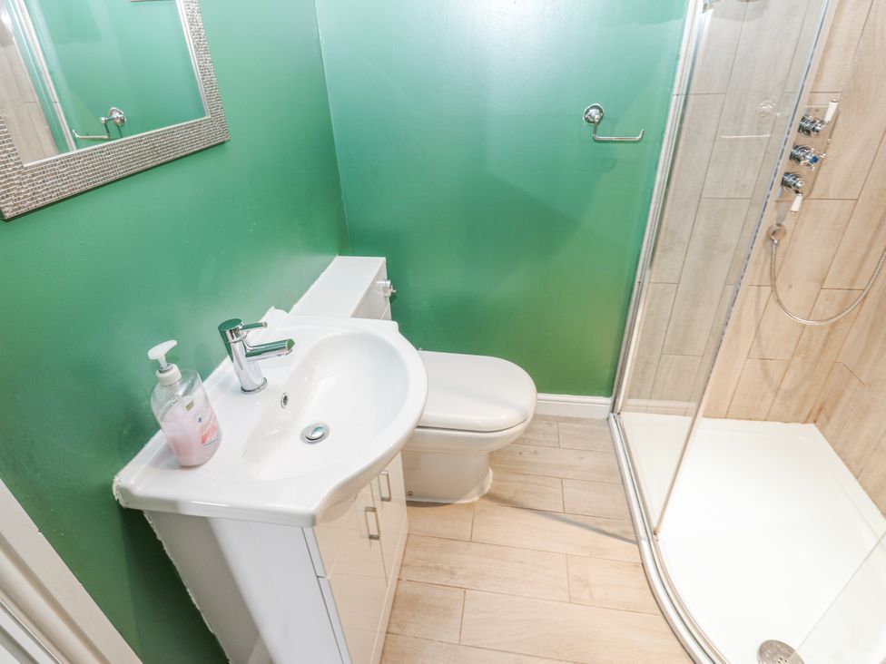 A bathroom with a sink and shower at The Granary Ellingstring near Masham