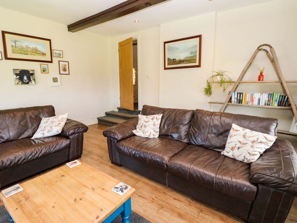 A living room with sofas and a coffee table at The Hayloft Ellingstring near Masham