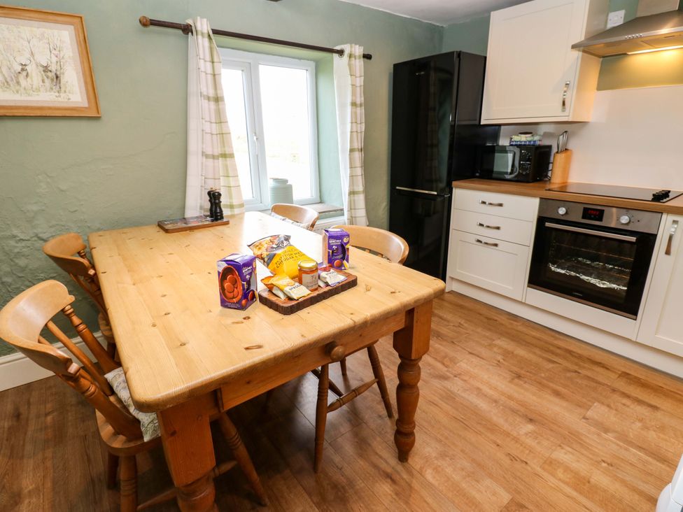 A kitchen with a table and food items at The Hayloft in Ellingstring near Masham