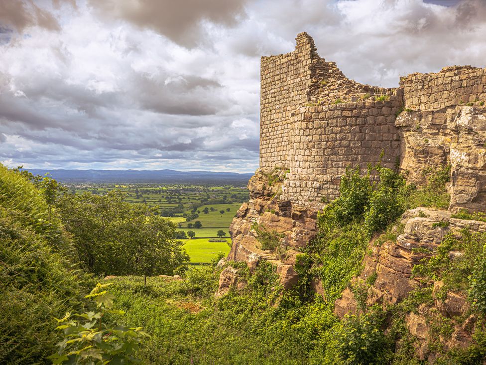 A view of ruins on a hill with surrounding landscape at 1 Fountain Cottages in Peckforton, Tarporley
