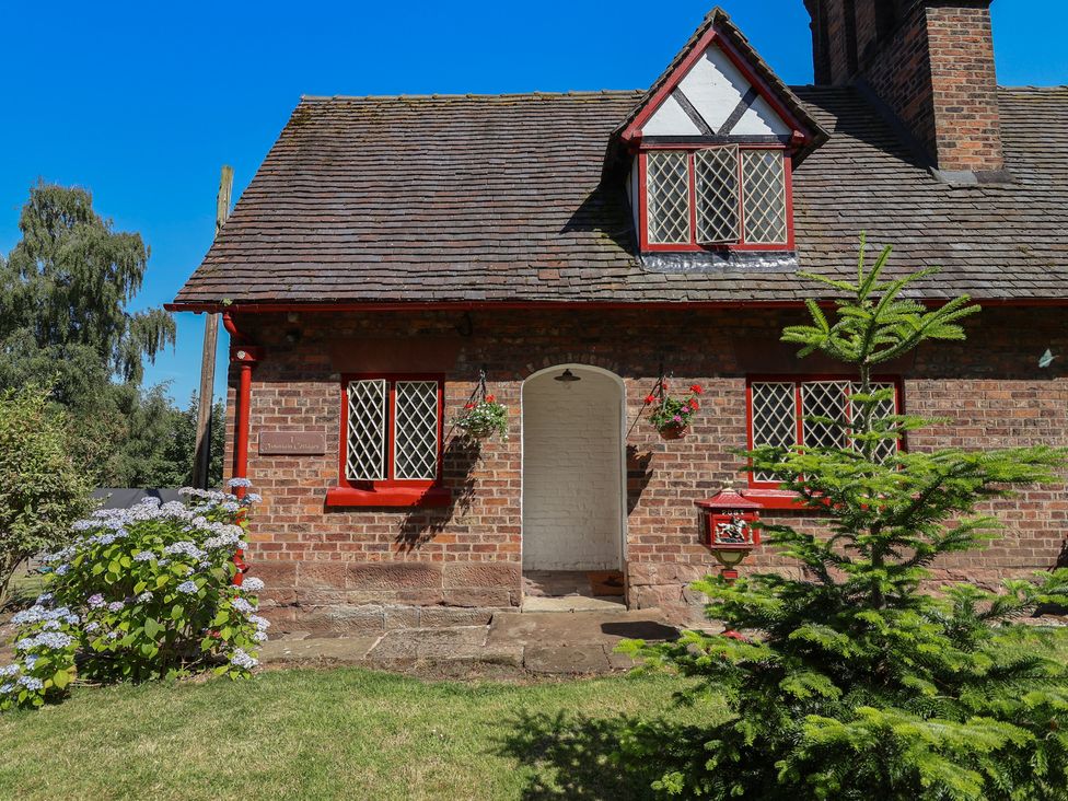 A house exterior with a door and windows at 1 Fountain Cottages in Peckforton, Tarporley