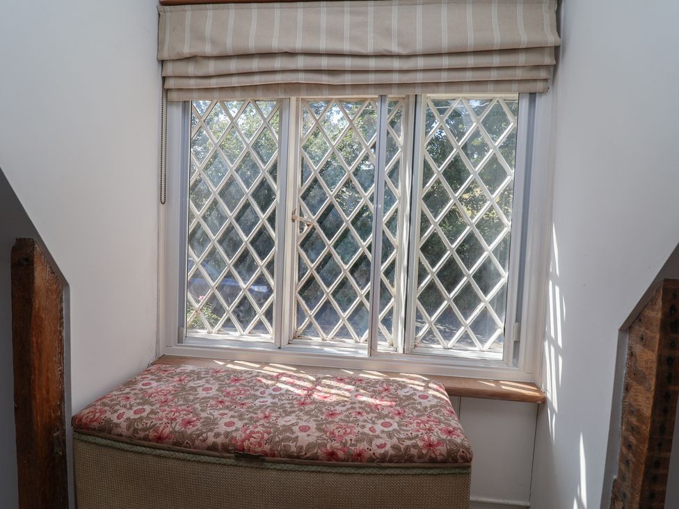 A snug with a window and a cushioned seat at 1 Fountain Cottages, Peckforton, Tarporley