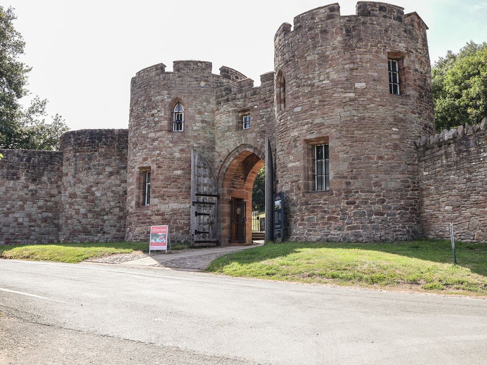 A castle entrance with stone walls and towers at 1 Fountain Cottages Peckforton Tarporley
