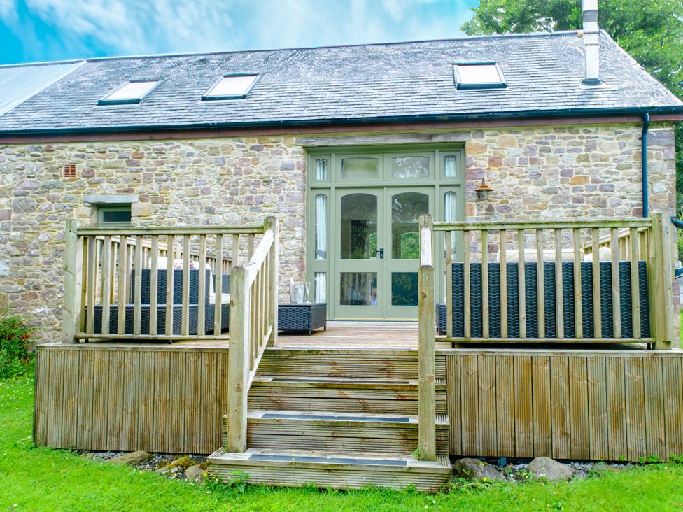 An outdoor area with deck and furniture at Gelli Barn Near Llandeilo