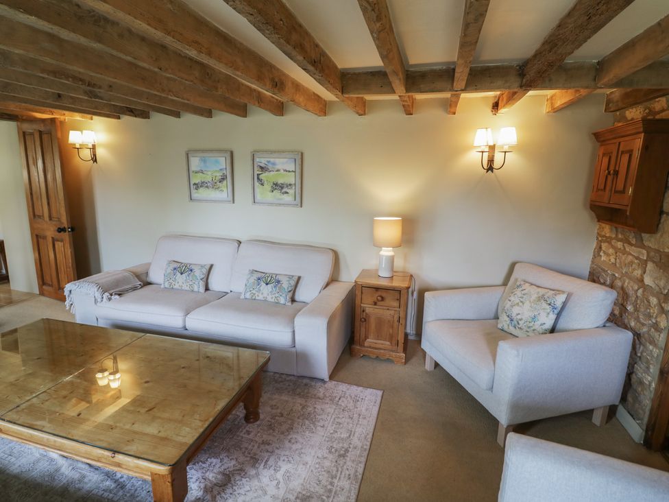 A living room with a sofa and coffee table at Robins Nest in Bourton-On-The-Water