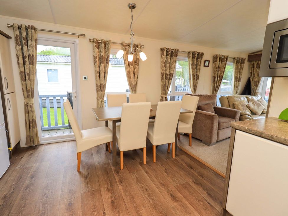 A dining room with a table and chairs at 41, Grandma's Cottage South Lakeland Leisure Village near Carnforth