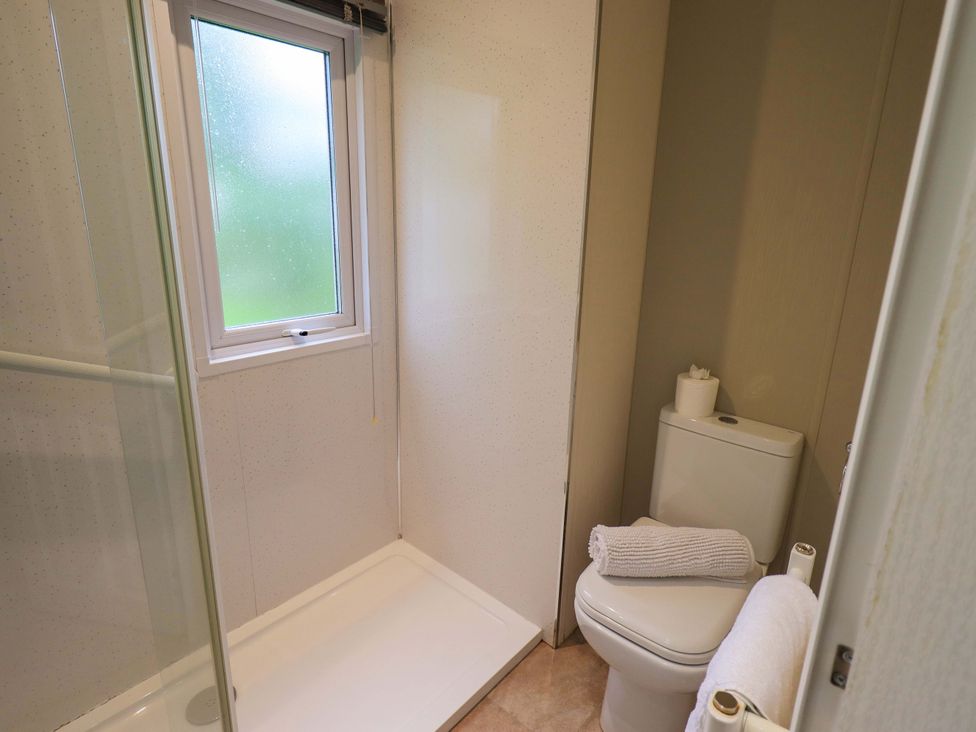 A bathroom with a shower and toilet at 41, Grandma's Cottage near South Lakeland Leisure Village