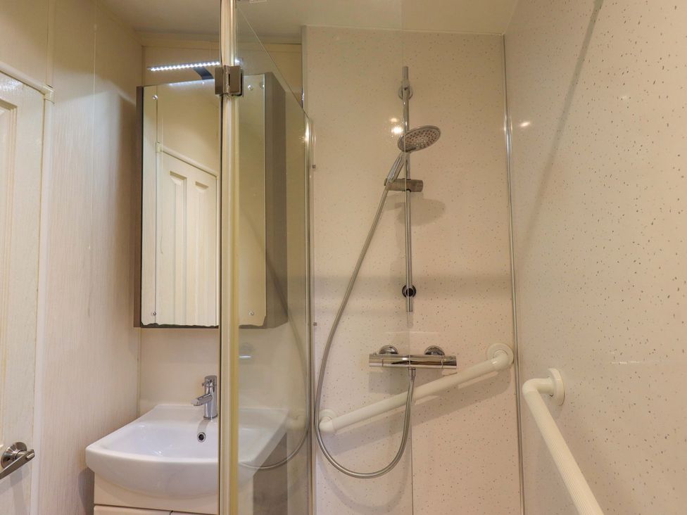 A bathroom with a shower and sink at 41, Grandma's Cottage near South Lakeland Leisure Village near Carnforth