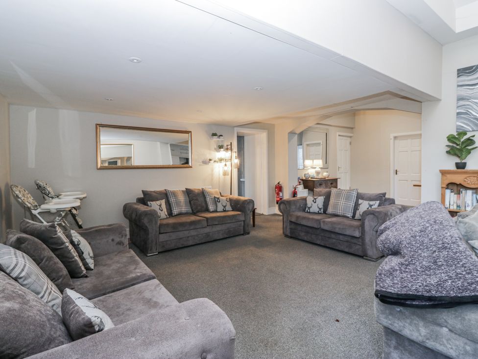 A living room with sofas and a mirror at Clarence House in Dalton-In-Furness