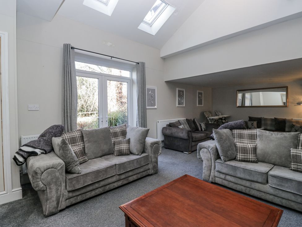 A living room with sofas and a coffee table at Clarence House in Dalton-In-Furness