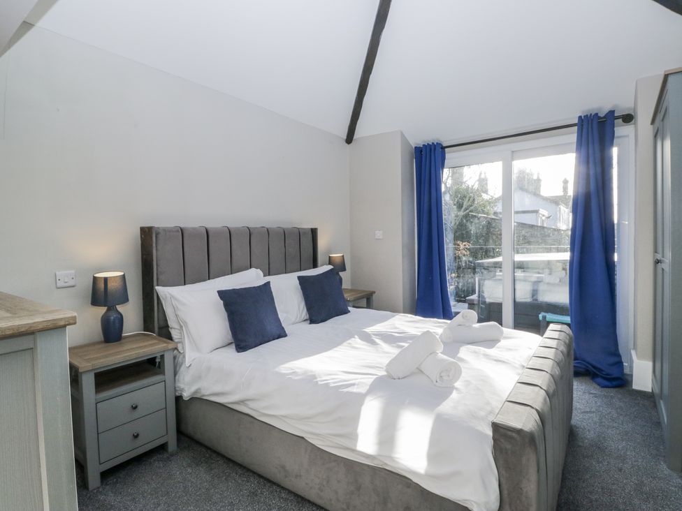 A bedroom with a bed and bedside table at Clarence House in Dalton-In-Furness