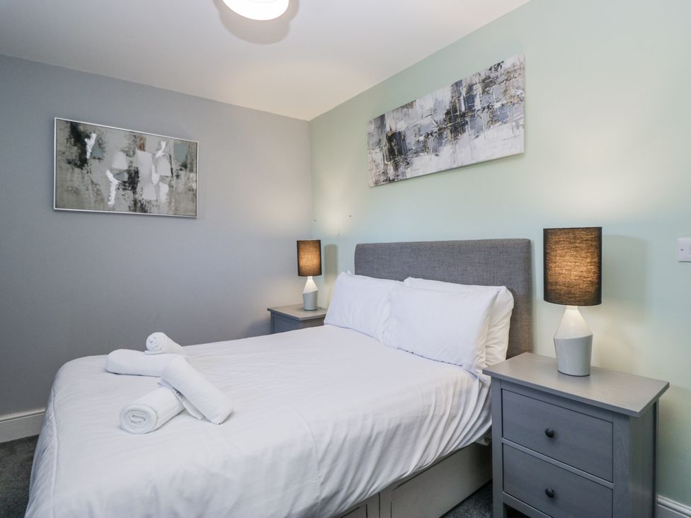 A bedroom with a bed and bedside tables at Clarence House in Dalton-In-Furness