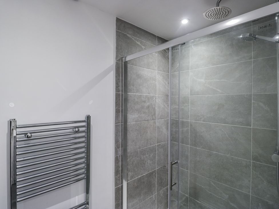 A bathroom with a shower and towel rail at Clarence House in Dalton-In-Furness
