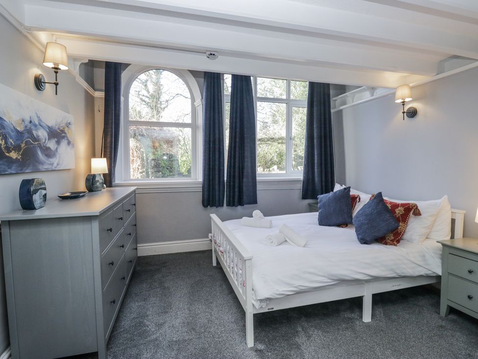 A bedroom with a bed and dresser at Clarence House in Dalton-In-Furness