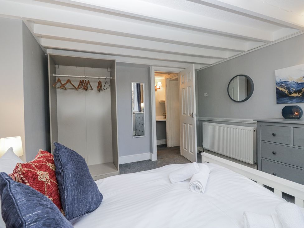 A bedroom with a bed and wardrobe at Clarence House Dalton-In-Furness