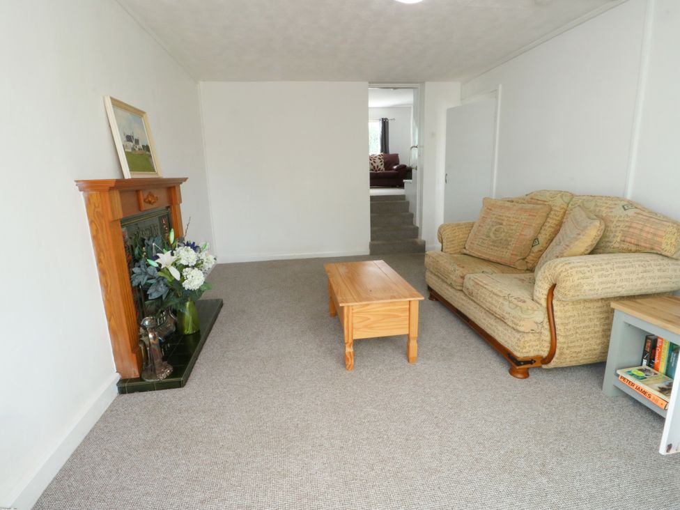 A living room with a sofa and a coffee table at Pen Bonc Llanddaniel Near Gaerwen